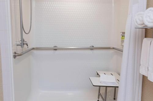 a white bathroom with a shower and a table at Holiday Inn Express & Suites - Olathe North by IHG in Olathe