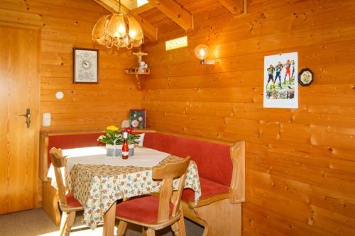 a wooden dining room with a table and chairs at Ferienwohnung Heidi Steinbacher in Ruhpolding