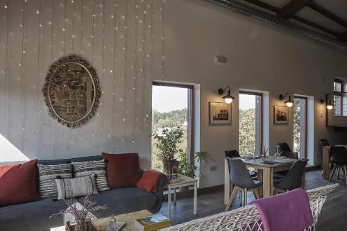 a living room with a couch and a table at Parga Natura Alojamiento in Parga