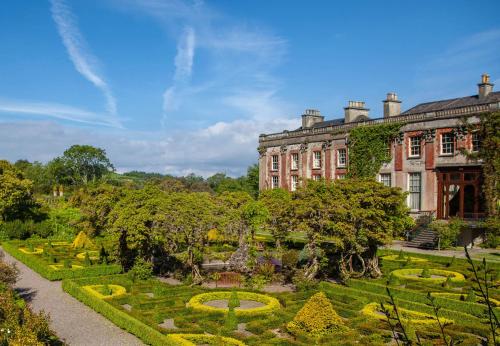 a large building with a garden in front of it at Island View Cottage Bantry by Trident Holiday Homes in Bantry