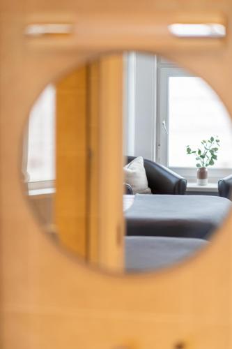 a mirror reflecting a couch in a living room at The Elizabeth in Sidmouth