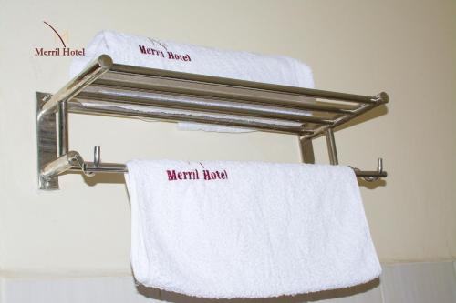 a towel rack with towels on it in a bathroom at Merril Hotel in Eldoret