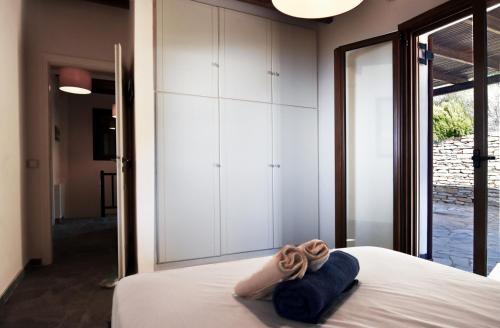 a bedroom with a bed with a towel on it at family home with a fantastic sea view, 5 minutes from the beaches in Koundouros
