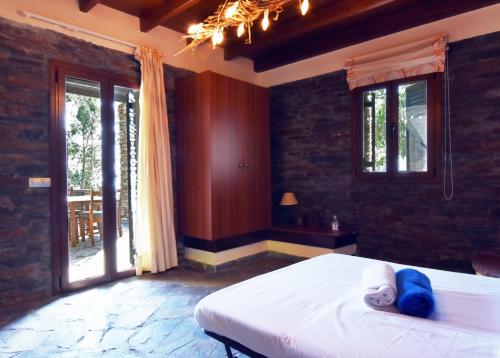 a bedroom with a bed and a large window at family home with a fantastic sea view, 5 minutes from the beaches in Koundouros