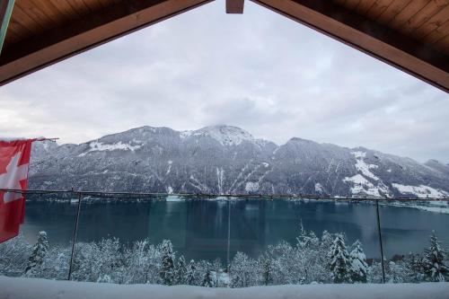 a view from a window of a lake and mountains at Exklusives Chalet mit traumhafter See- und Bergsicht in Seelisberg