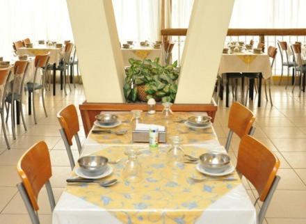 
a dining room table with chairs and a table cloth at BALOO Hotel in Mar del Plata
