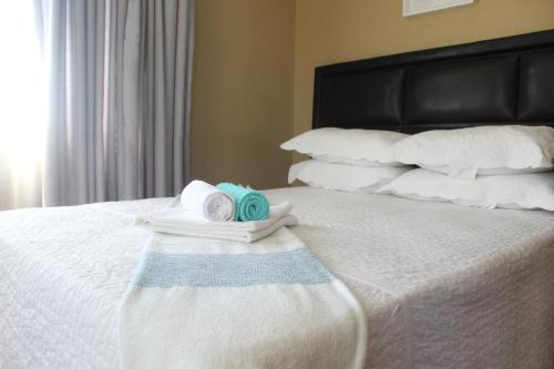 a white bed with towels on it at The Anne Guest House in Maseru