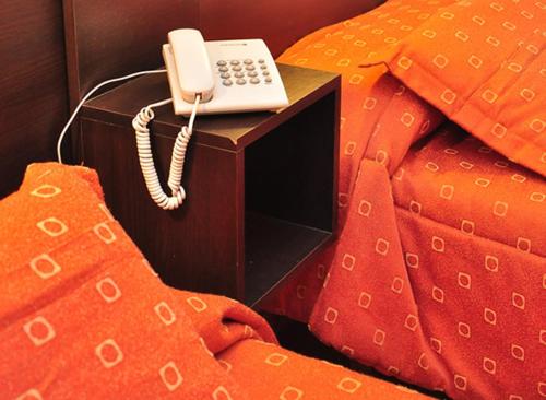 a phone sitting on top of a bed at BALOO Hotel in Mar del Plata