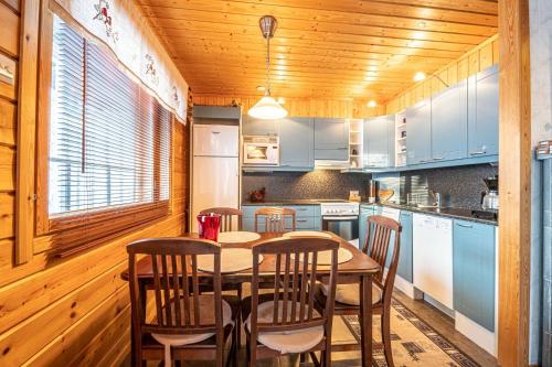 a kitchen with a table and chairs in a room at Rentorakka in Kittilä