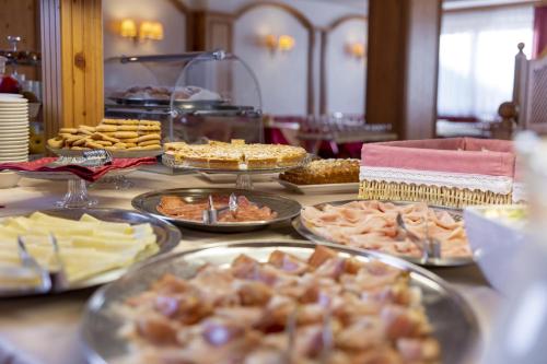a buffet with many different types of food on a table at Hotel Cristallo in Canazei