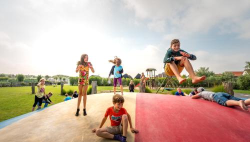 a group of children playing on a playground at Camping Veld & Duin in Bredene