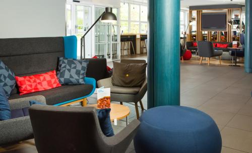 a lobby with couches and chairs and a table at Holiday Inn Express Burton on Trent by IHG in Burton upon Trent