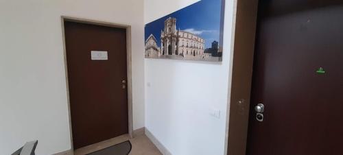 a room with a door and a picture on the wall at BARBARA Classy Apartments 103, Wellness in Siracusa
