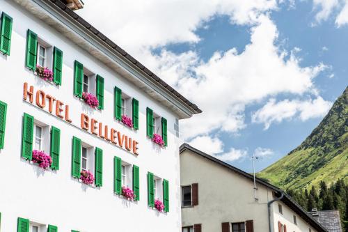 a building with green shutters and flowers on it at Hotel Bellevue in San Bernardino