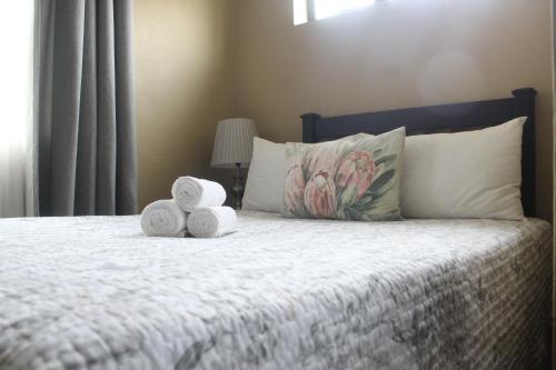 a bedroom with a bed with towels on it at The Anne Guest House in Maseru