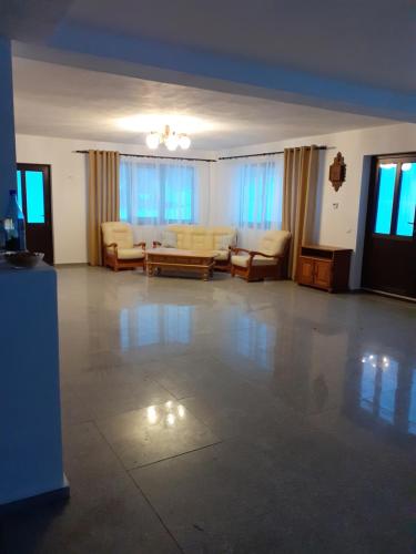 a large living room with couches and a table at Pensiunea Natura Sadu in Sibiu
