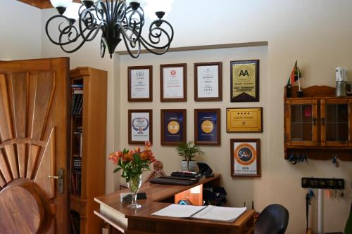 an office with a desk and a chandelier at Lamor Guest House in Middelburg