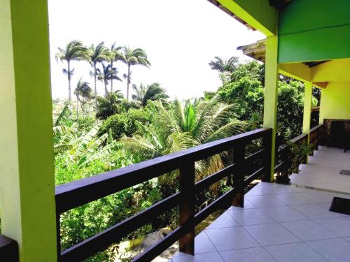 a view from the balcony of a resort with palm trees at Wando Suítes in Búzios