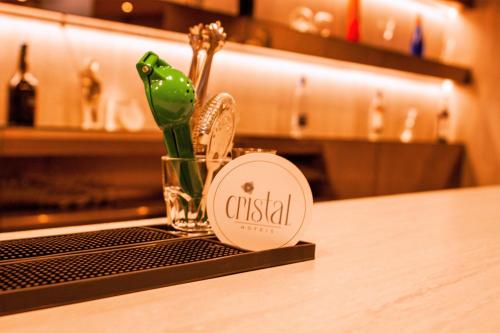 a small glass figurine of a frog sitting on a table at Hotel Cristal Setúbal in Setúbal