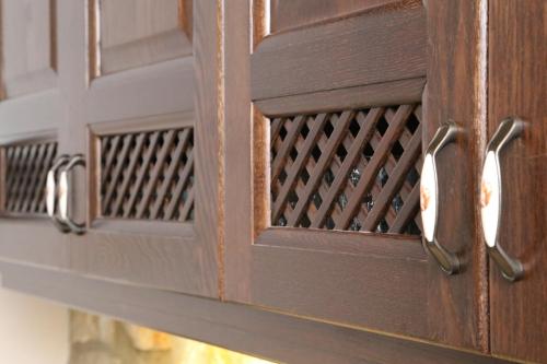 a wooden door with metal handles on it at Petrines Villes Avramilias in Avramiliá