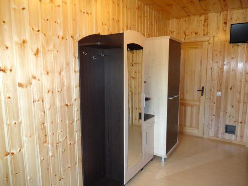 a room with wood paneled walls and a elevator at Country Houses Vidų Sodyba in Utena