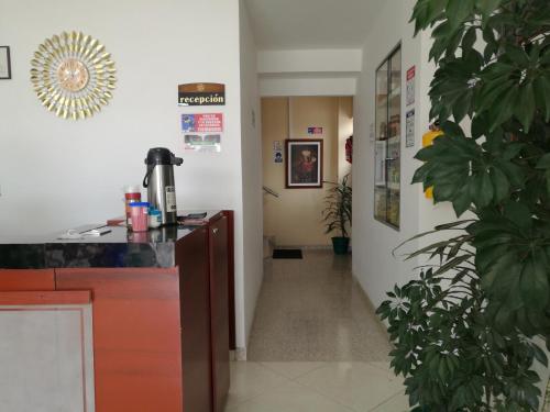 a corridor of a hospital with a hallway leading into a room at Hotel Suyusama in Ipiales