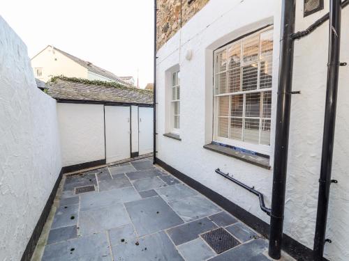 an empty courtyard with a window and a building at Lluest in Beaumaris