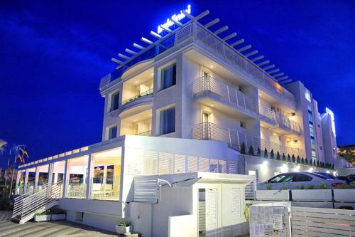 a large white building with lights on top of it at Baldinini Hotel in Rimini