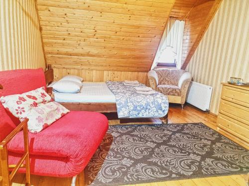 a small room with a bed and a chair at Вотавілю Драгобрат in Dragobrat