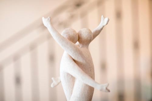 a plastic figurine of two people jumping up at Cala di Ponente in Castelluzzo