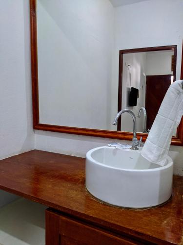 a bathroom with a sink and a mirror at Pousada Luz do Porto in Porto De Galinhas