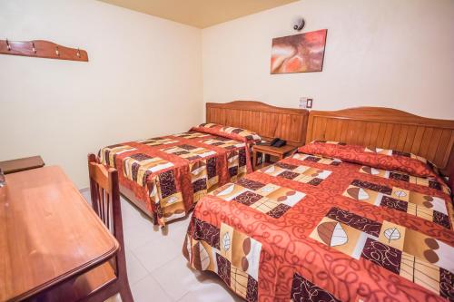 Postel nebo postele na pokoji v ubytování Hotel Márquez