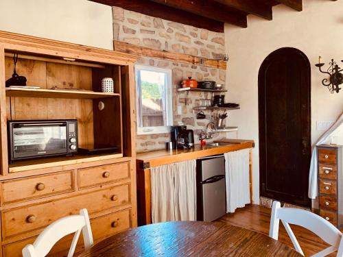 a kitchen with a table and a microwave at Under the Tuscan Sun Cottage in West Los Angeles in Los Angeles