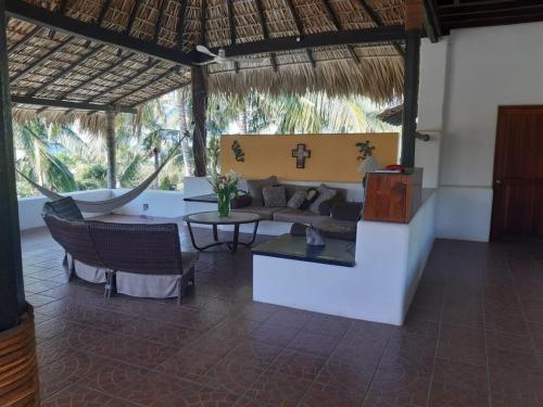 a living room with a couch and a table at Casa Maya private villa on the beach in Puerto Escondido