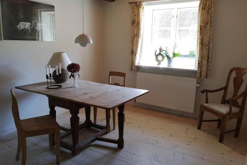a dining room with a wooden table and chairs at Foxhouse in Præstø