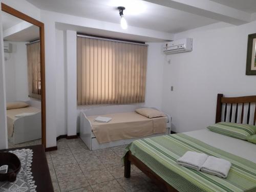 Cama o camas de una habitación en Pousada Baleia Franca Canasvieiras