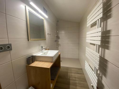 a bathroom with a sink and a mirror at Pension Marina in Tux