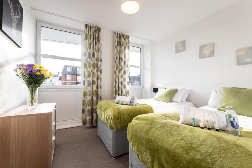 a hotel room with two beds and a window at Smart Apartments - Empress Heights in Southampton