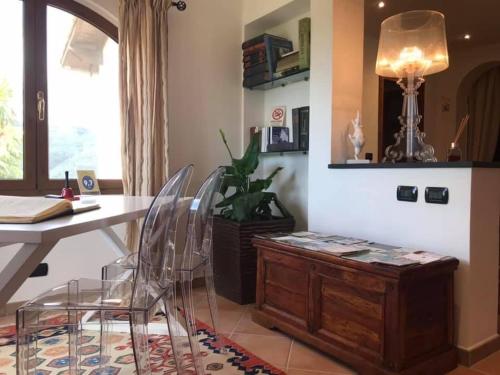 a room with a table and chairs and a desk at Moonlight- Bedbluesky in Perinaldo