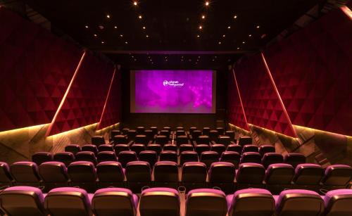 an auditorium with a screen and chairs in front at Planet Hollywood Adult Scene Cancun, An Autograph Collection All- Inclusive Resort - Adults Only in Cancún