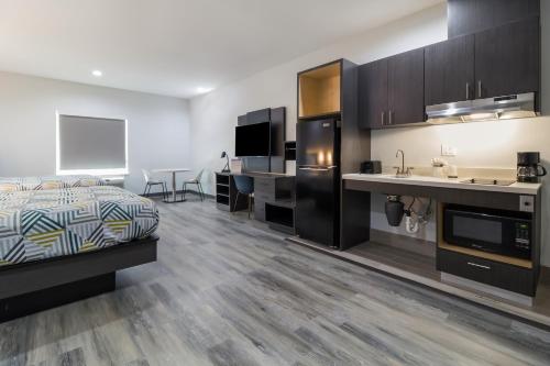 a large room with a bed and a kitchen at Studio 6 Katy, Tx in Katy