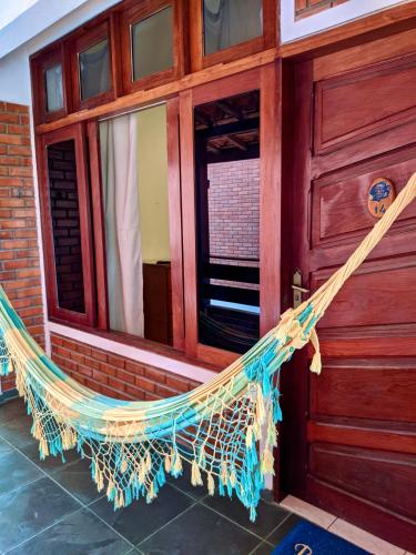 a hammock hanging outside of a building at Pousada Luz do Porto in Porto De Galinhas