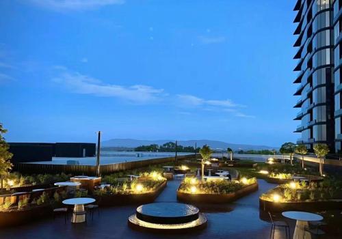 a view of a city at night with tables and buildings at Skygarden Luxury Condo in Glen Waverley