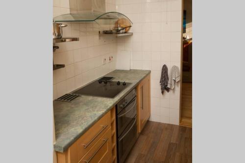 a kitchen with a sink and a stove at Mallaig Self Catering Apartment in Mallaig