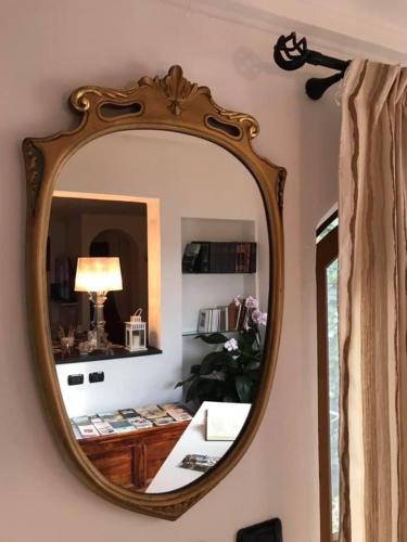 a mirror hanging on a wall in a room at Moonlight- Bedbluesky in Perinaldo
