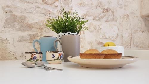 a table with a plate of bread and coffee cups at La Vernèa in Ceglie Messapica