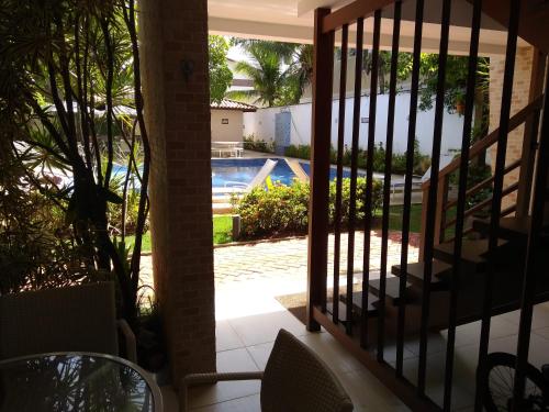 a balcony with a view of a swimming pool at Laguna Ville 08 in Itacimirim