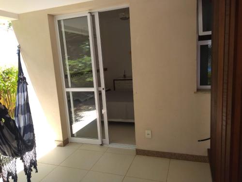 a sliding glass door in a room with a patio at Laguna Ville 08 in Itacimirim
