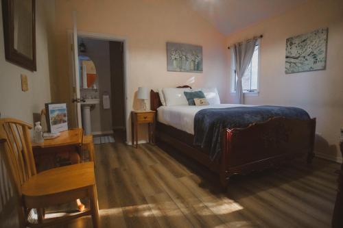 a bedroom with a bed and a table and a chair at Tucker Peak Lodge in Julian