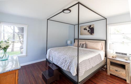 a bedroom with a canopy bed and a window at Apple Tree Inn in Julian